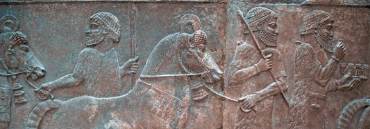Ancient Sumerian stone relief showing figures and animals in a ceremonial or daily life scene.